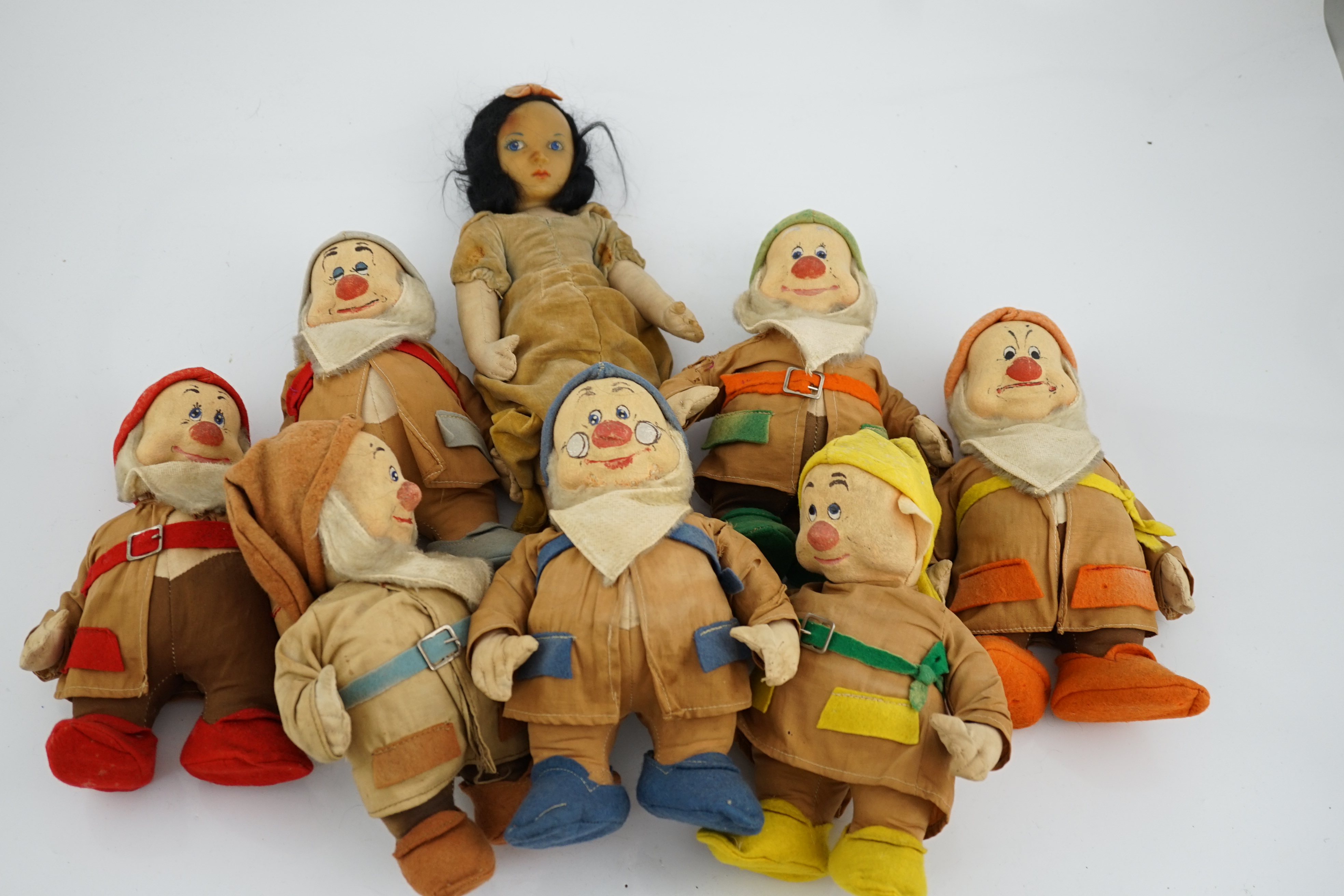 A set of Merrythought Snow White and the Seven Dwarves, Snow White with Merrythought label to the sole of her foot, the Dwarves could possibly be made by either Merrythought or Chad Valley, Snow White 36cm high